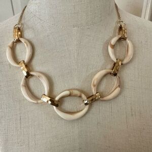 1946 tan and gold tone  oval  shaped necklace